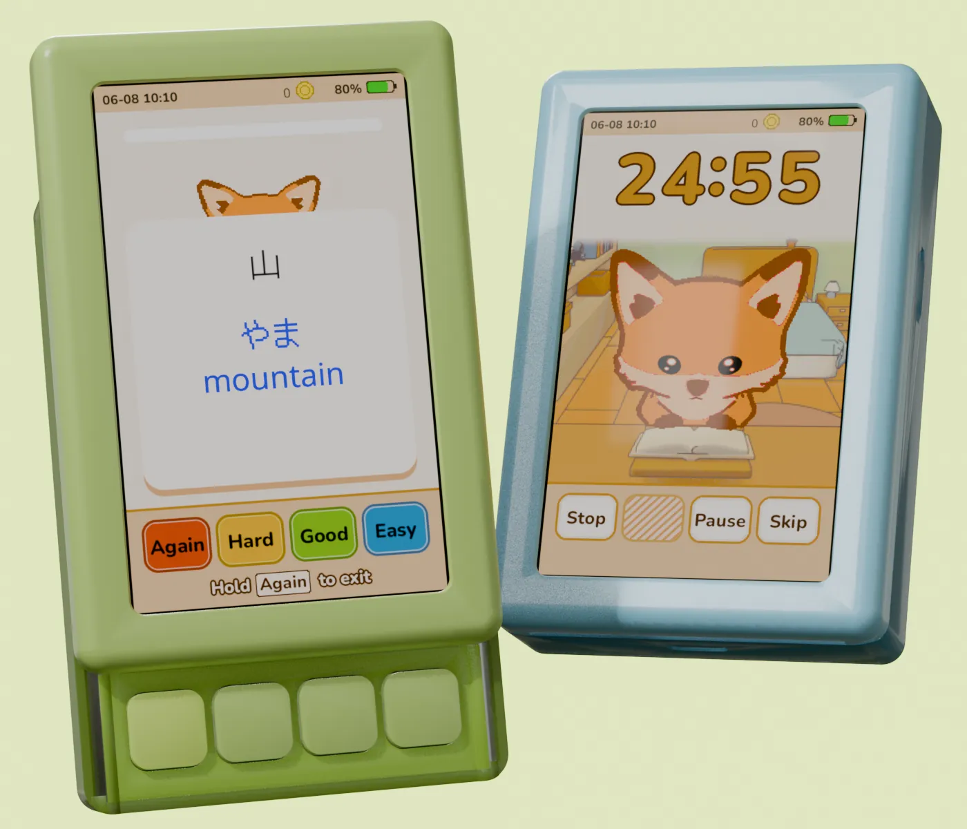 Two kotohi devices at an angle: the nearer one open with a Japanese flashcard, the one behind shut, showing a focus timer with the fox reading.